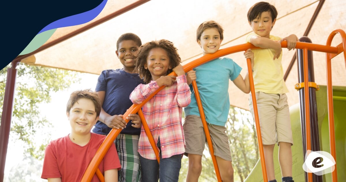 Children standing on play equipment under a shade cloth